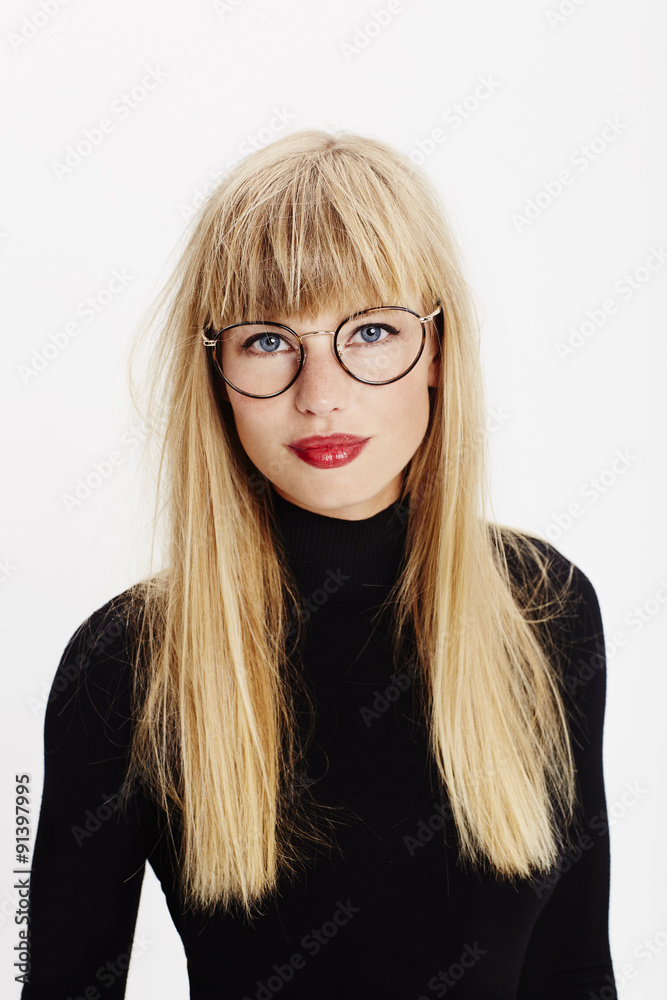 Portrait of studious young woman in spectacles