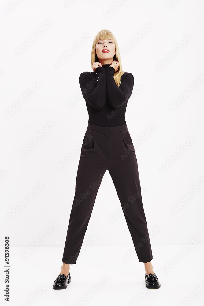 Fototapeta premium Confident young woman in black in portrait