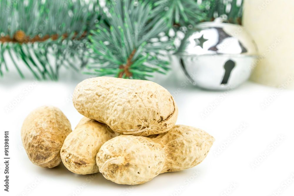 four peanuts in shell and christmas decoration four peanuts in shell and christmas decoration