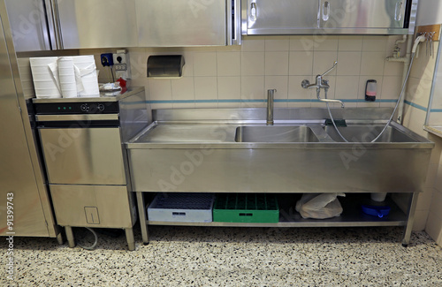 large stainless steel sink of industrial kitchen for preparing f photo