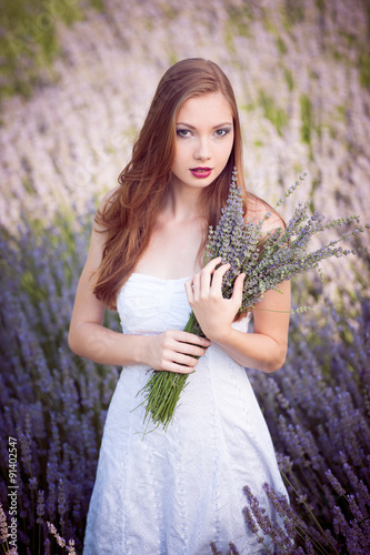 Beautiful young woman on lavender field