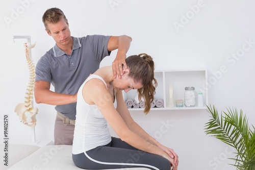 Doctor doing neck adjustment photo