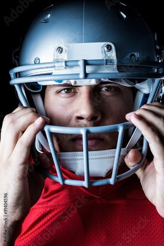 Close-up portrait of sportsman holding helmet
