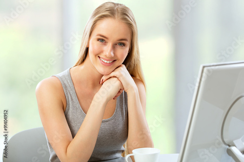 Young woman using computer at home Free Download Young woman using computer at home - GFXLoad