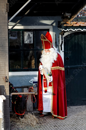 Saint Nicholas is feeding his little horse