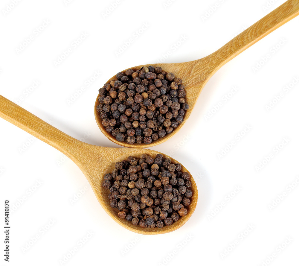 Wooden spoon and black peppercorn on white background Wooden spoon and black peppercorn on white background