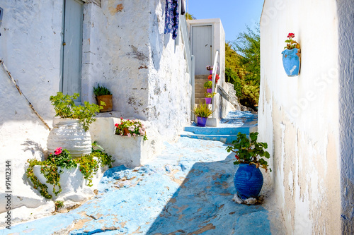 Fototapeta Naklejka Na Ścianę i Meble -  Beautiful street in old traditional Greek cycladic village Plaka