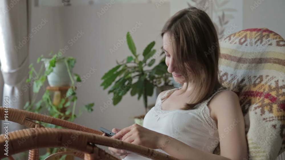 Young beautiful woman sitting with smart phone. Young beautiful woman sitting with smart phone.