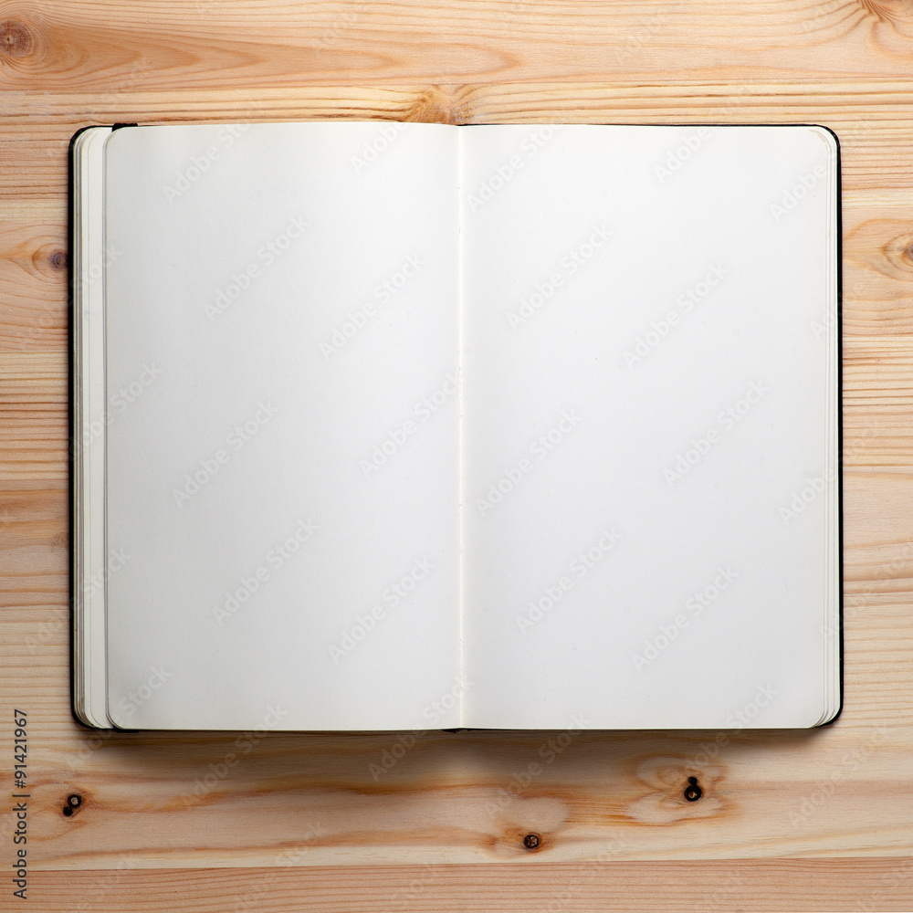 Open notebook on a wooden table Open notebook on a wooden table