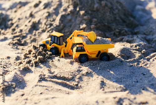 sand mining. toy truck and excavator mining of sand in a quarry