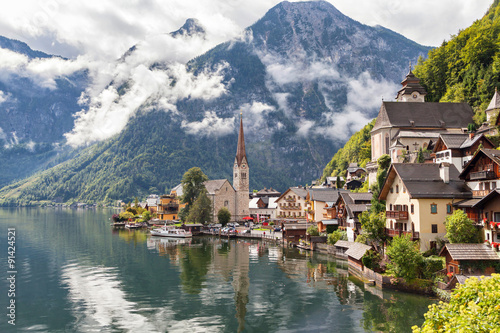Hallstatt village in Austrian Alps with clouds and mountain lake © bbsferrari