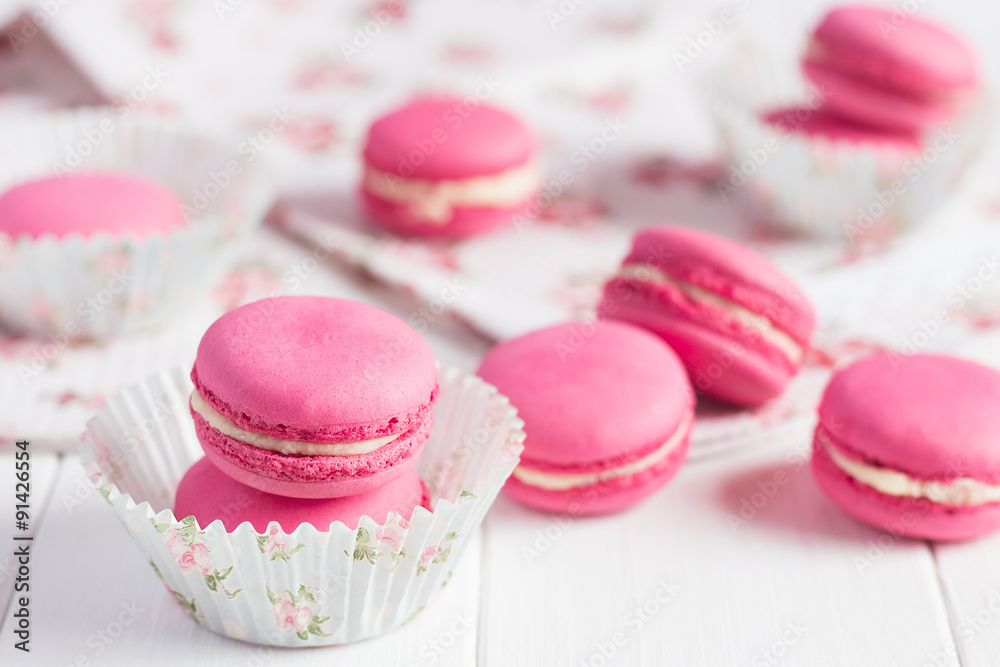 Pink raspberry macaroons on white wooden background Pink raspberry macaroons on white wooden background