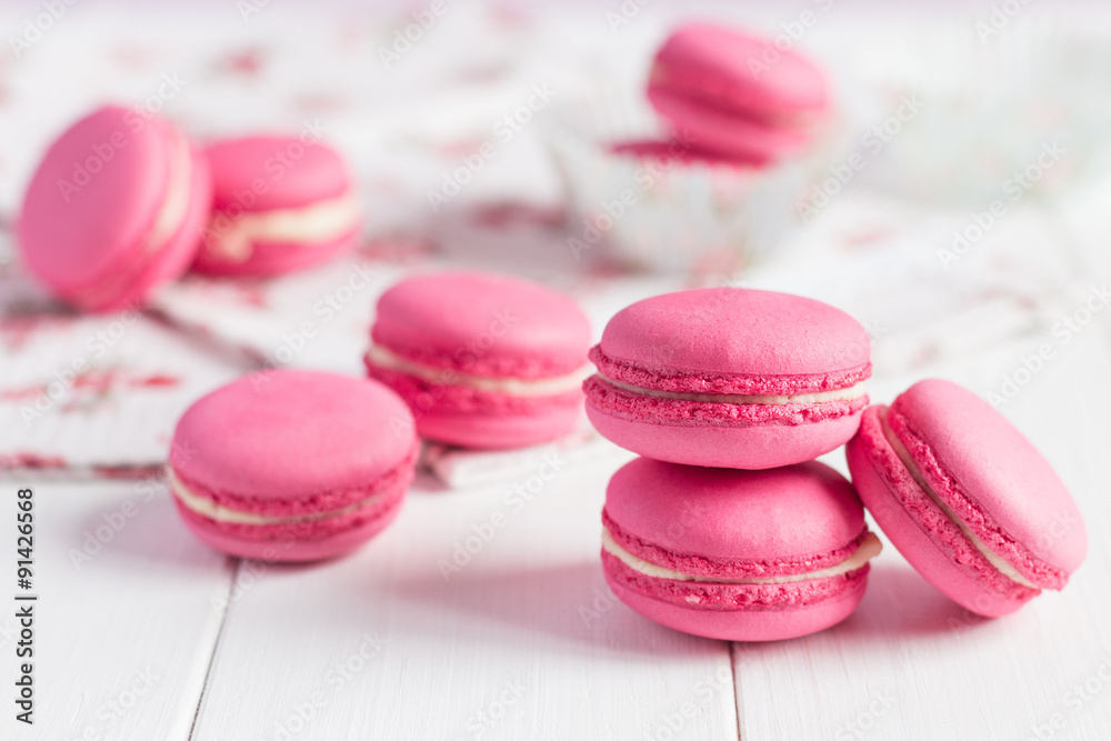 Pink raspberry macaroons on white wooden background Pink raspberry macaroons on white wooden background