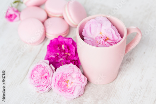 Tea cup with rose and macaroons