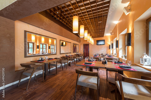 Restaurant room with wooden furniture photo