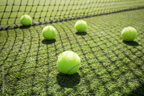 Tennis balls on the court grass © Kaspars Grinvalds
