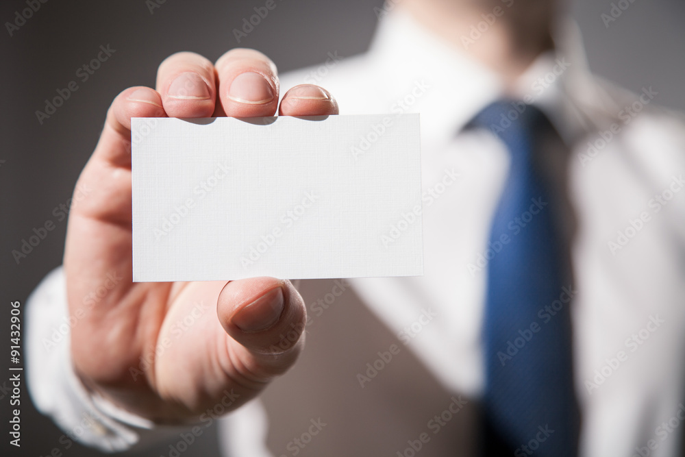 Businessman's hand showing visiting card Businessman's hand showing visiting card