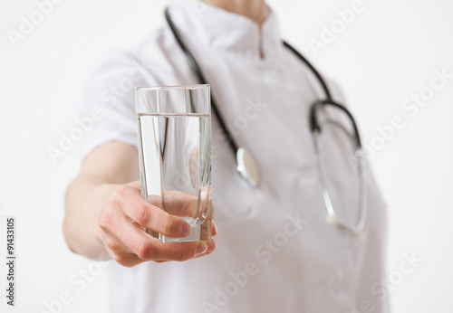 Doctor holding a glass with drug