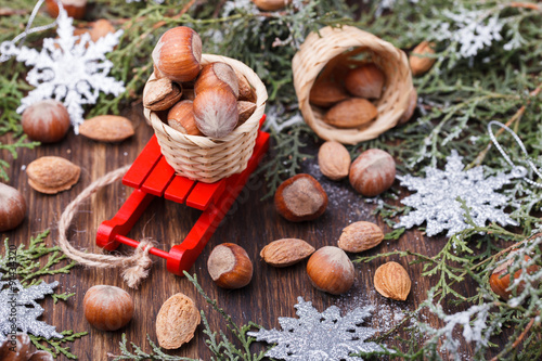 Christmas And New Year Holiday decoration. Cones, almonds and hazelnuts on a sled.