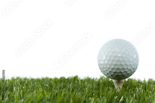 Golfball on a tee in the grass