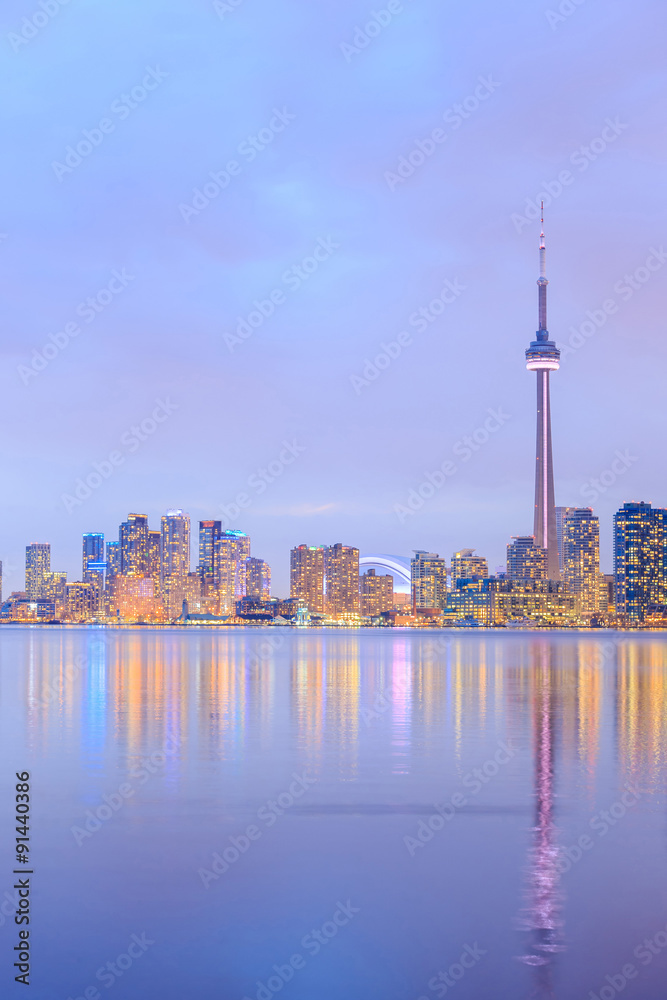 Toronto city dusk over lake with colorful light