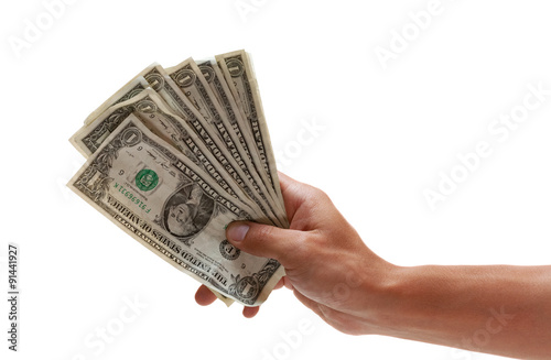 Hand holding out some worn dollar bills