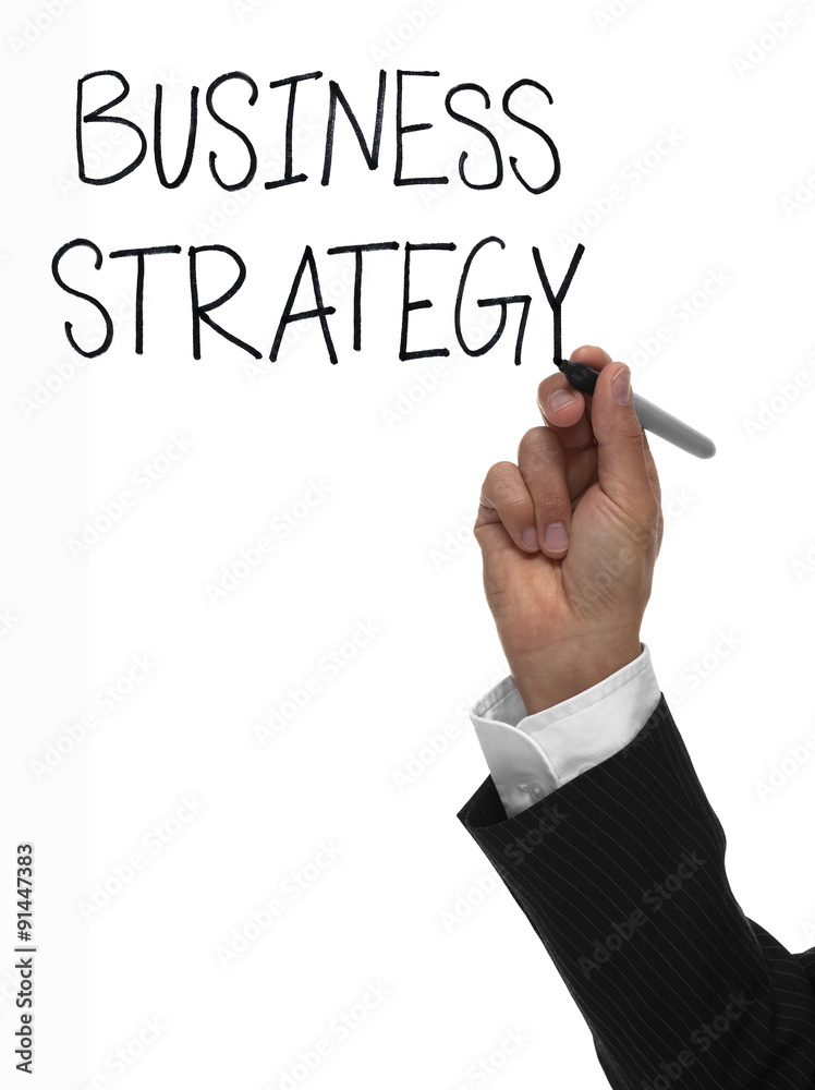 Hand writing the words business strategy Hand writing the words business strategy
