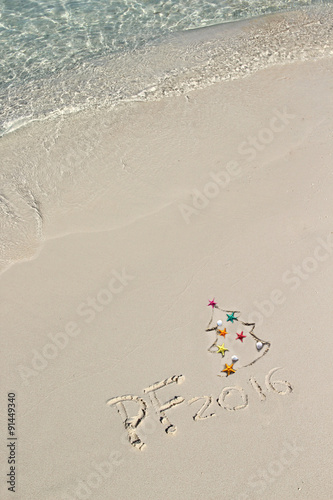 Handwriting inscription PF 2016 on the beach