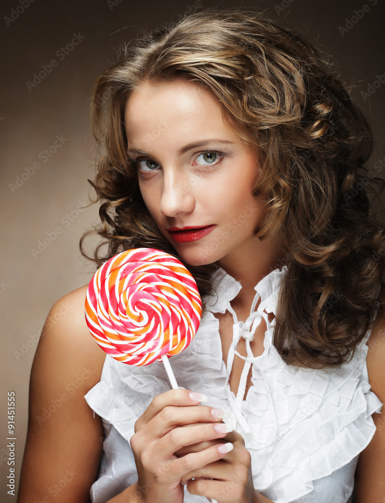 Lollipop in hand. Beautiful  girl with  candy.