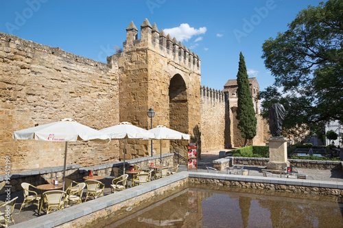 CORDOBA, SPAIN - MAY 25, 2015: The statue of philosopher Lucius Annaeus Seneca the Younger by Amadeo Ruiz Olmos (1913 - 1993) and medieval gate Puerta del Almodovar.