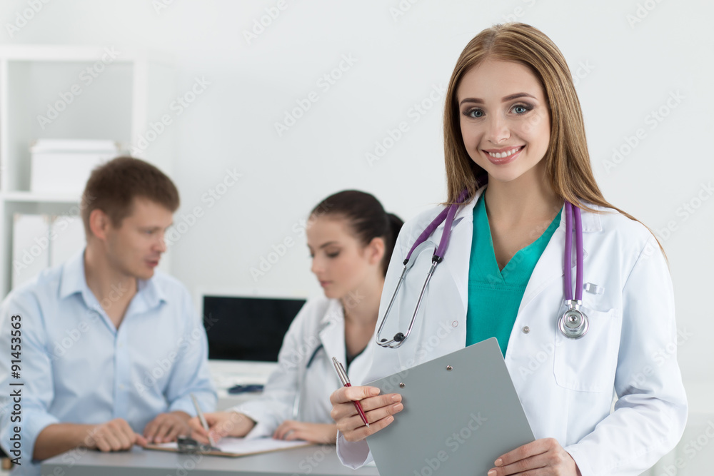 Portrait of smiling female medicine doctor with her colleague co Portrait of smiling female medicine doctor with her colleague co