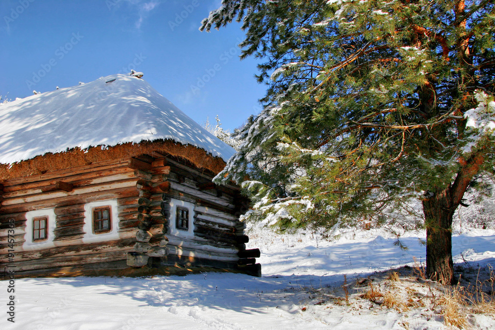 Bright elegant house under a thatched roof in the snow. Christma