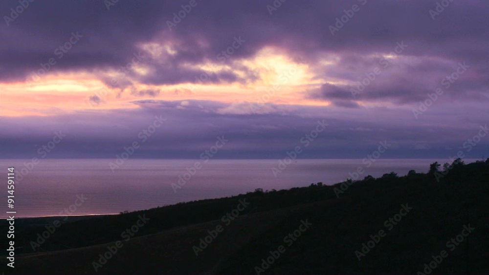 Time lapse shot of clouds moving over the ocean at sunset. Time lapse shot of clouds moving over the ocean at sunset.