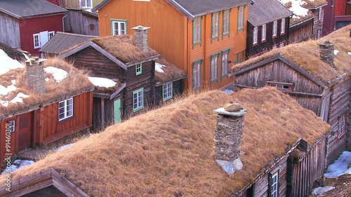 Thatch roofed wooden buildings line the streets of the old historic mining town of Roros in Norway. photo