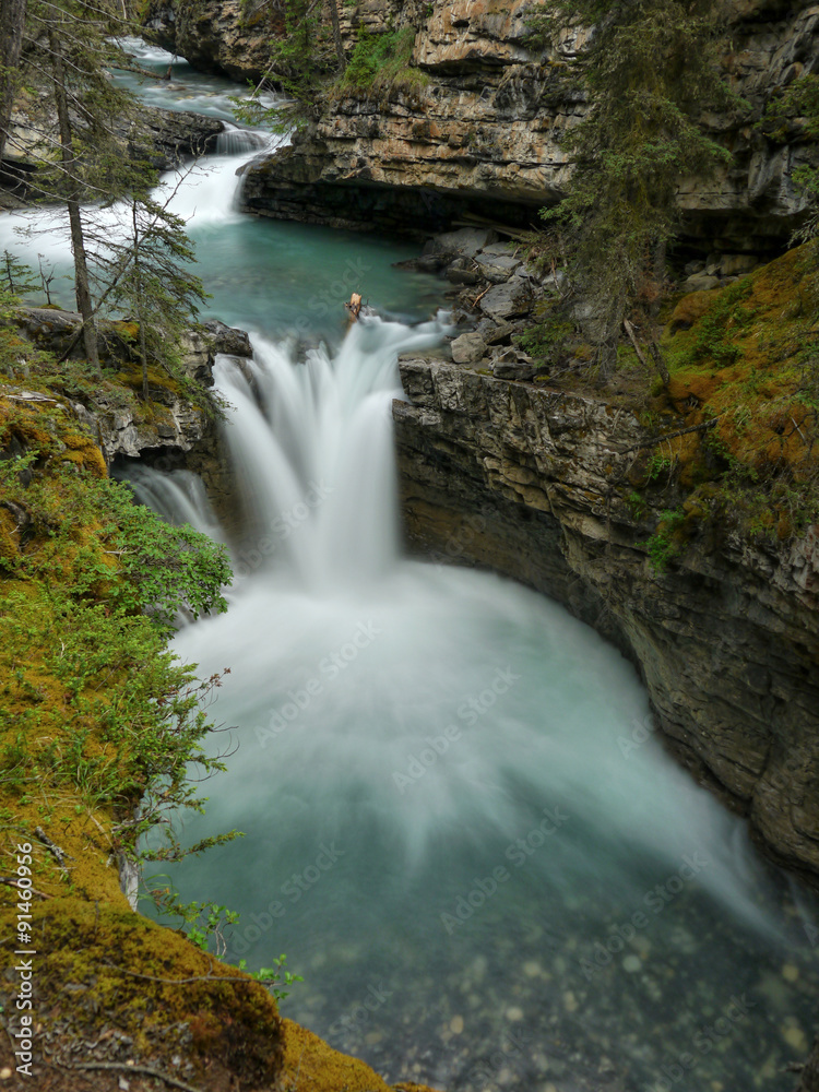 Fototapeta premium Waterfall into a wild gorge, Canadian Rockies