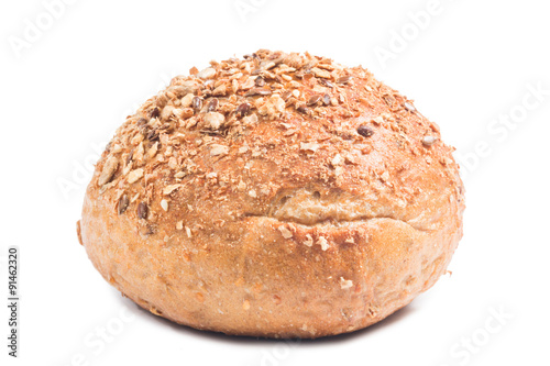 Fresh whole grain bread cut in half on white background 