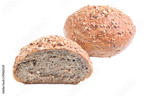 Fresh whole grain bread cut in half on white background 