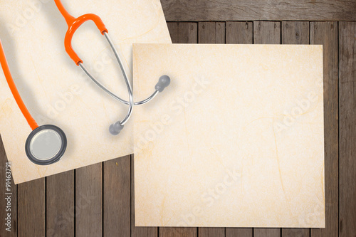 stethoscope and paer on wood with abstract  background. photo