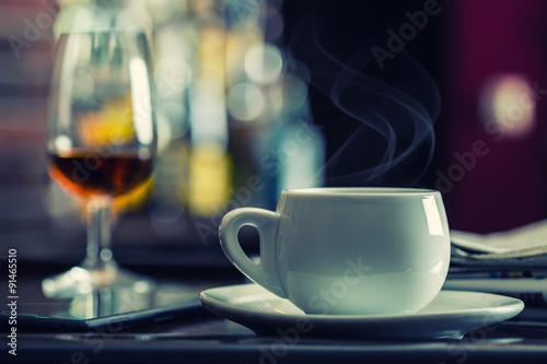 Coffee and drink. Cup of Coffee and Cognac Brandy Whiskey Aperitif in modern night bar