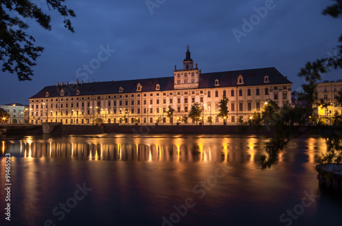 Odra river waterfront in Wroclaw  Poland  with main university building  in early morning  seen from University Bridge