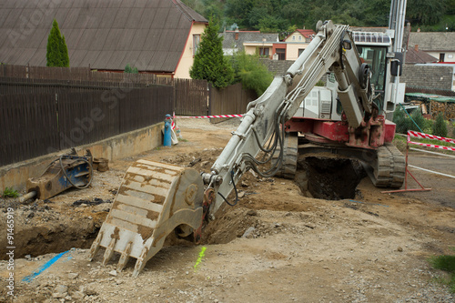 excavator ploughshare on trench - constructing canalization photo