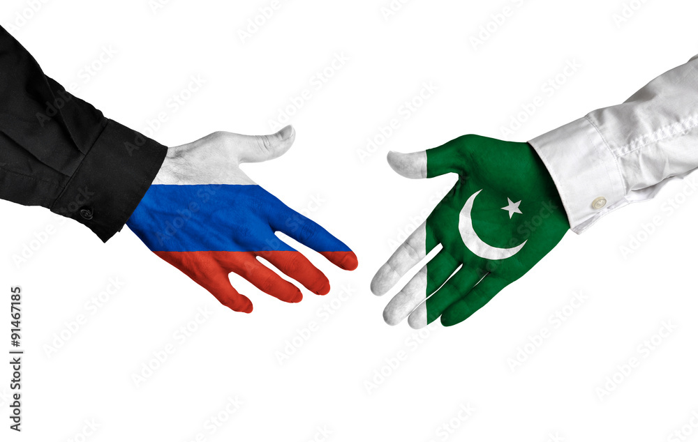 Russia and Pakistan leaders shaking hands on a deal agreement