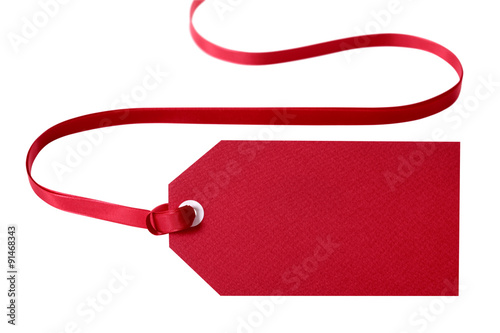 Red gift tag for christmas or birthday present tied with ribbon isolated on white background photo