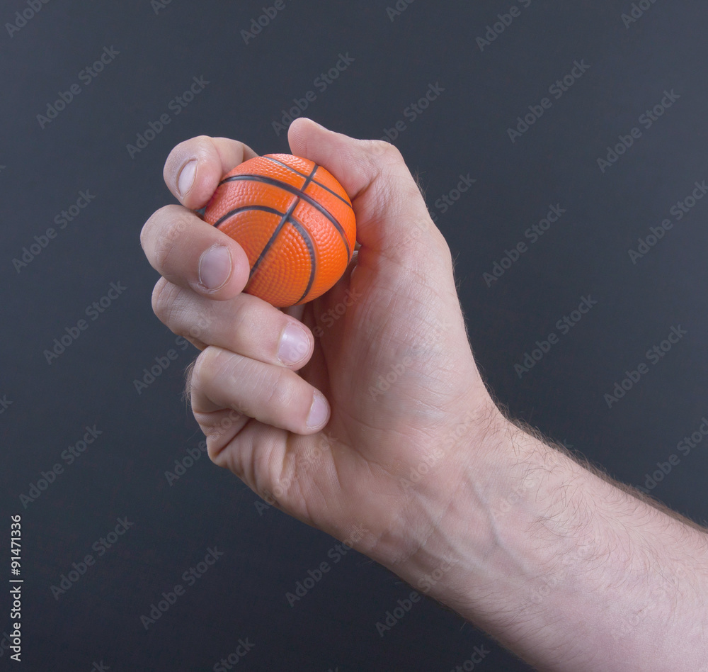 Isolated hand with a mini basket ball