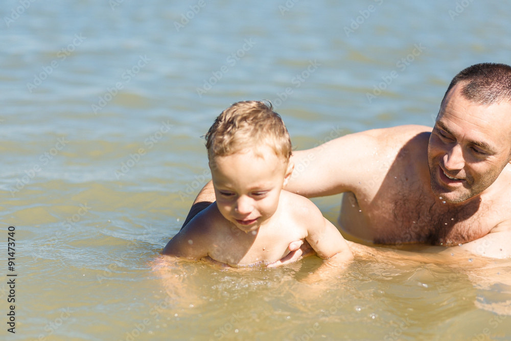 Father teaching his son to swim Father teaching his son to swim