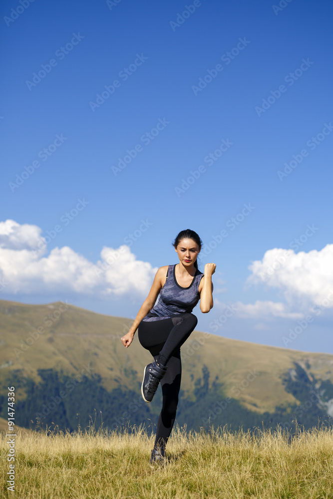 Exercising fitness woman doing exercises in nature. Girl doing m Exercising fitness woman doing exercises in nature. Girl doing m