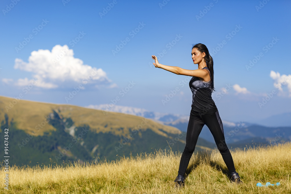 Exercising fitness woman doing exercises in nature. Girl doing m Exercising fitness woman doing exercises in nature. Girl doing m