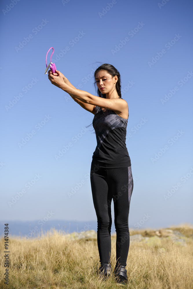 Exercising fitness woman doing exercises in nature. Girl doing m Exercising fitness woman doing exercises in nature. Girl doing m