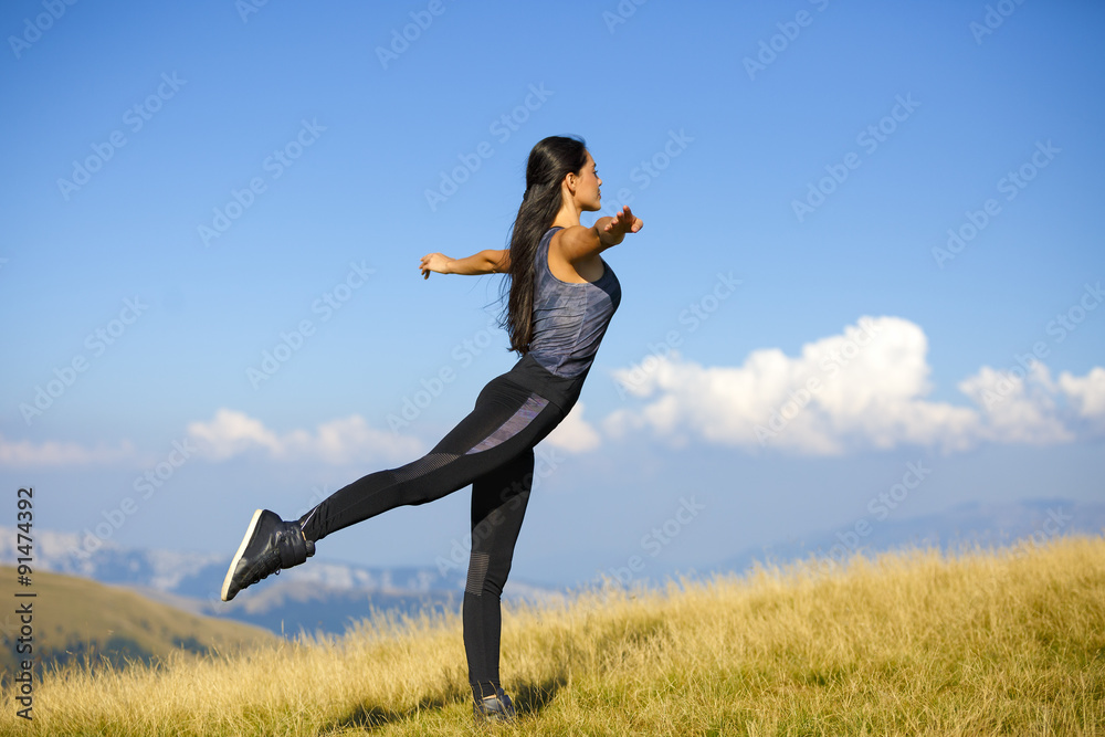 Exercising fitness woman doing exercises in nature. Girl doing m Exercising fitness woman doing exercises in nature. Girl doing m