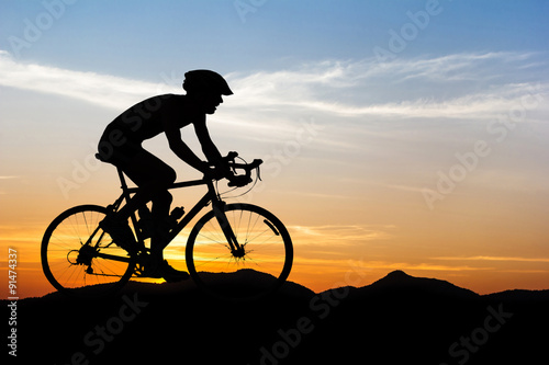 Man cycling at mountain on twilight